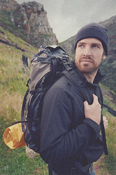 a man in hiking gear and backpack standing in nature