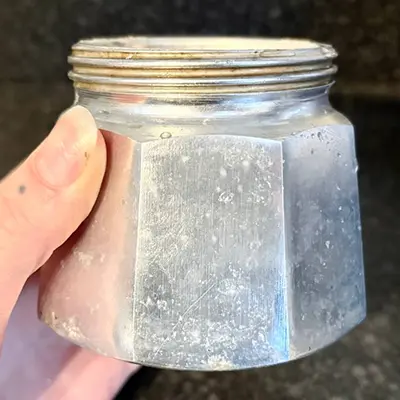 The moka pot base in a hand