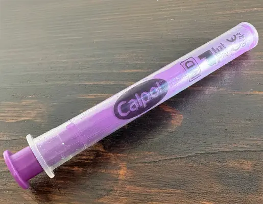 A close up of the syringe from a calpol bottle