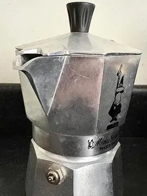 A side view of the moka pot, showing the tapered spout
