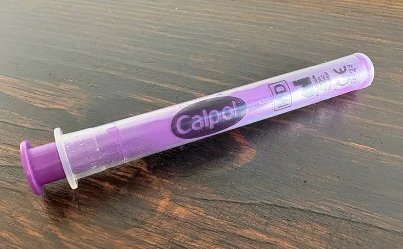 A close up of the syringe from a calpol bottle