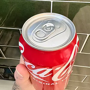 A can of coca cola from above, showing the lip and pop tab